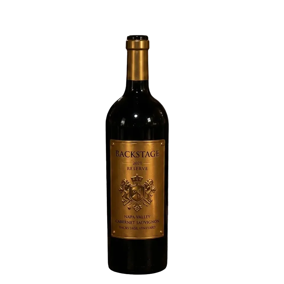 Isolated product shot of Backstage 2021 Reserve Napa Valley Cabernet Sauvignon wine bottle with gold label and foil capsule on a neutral grid background.